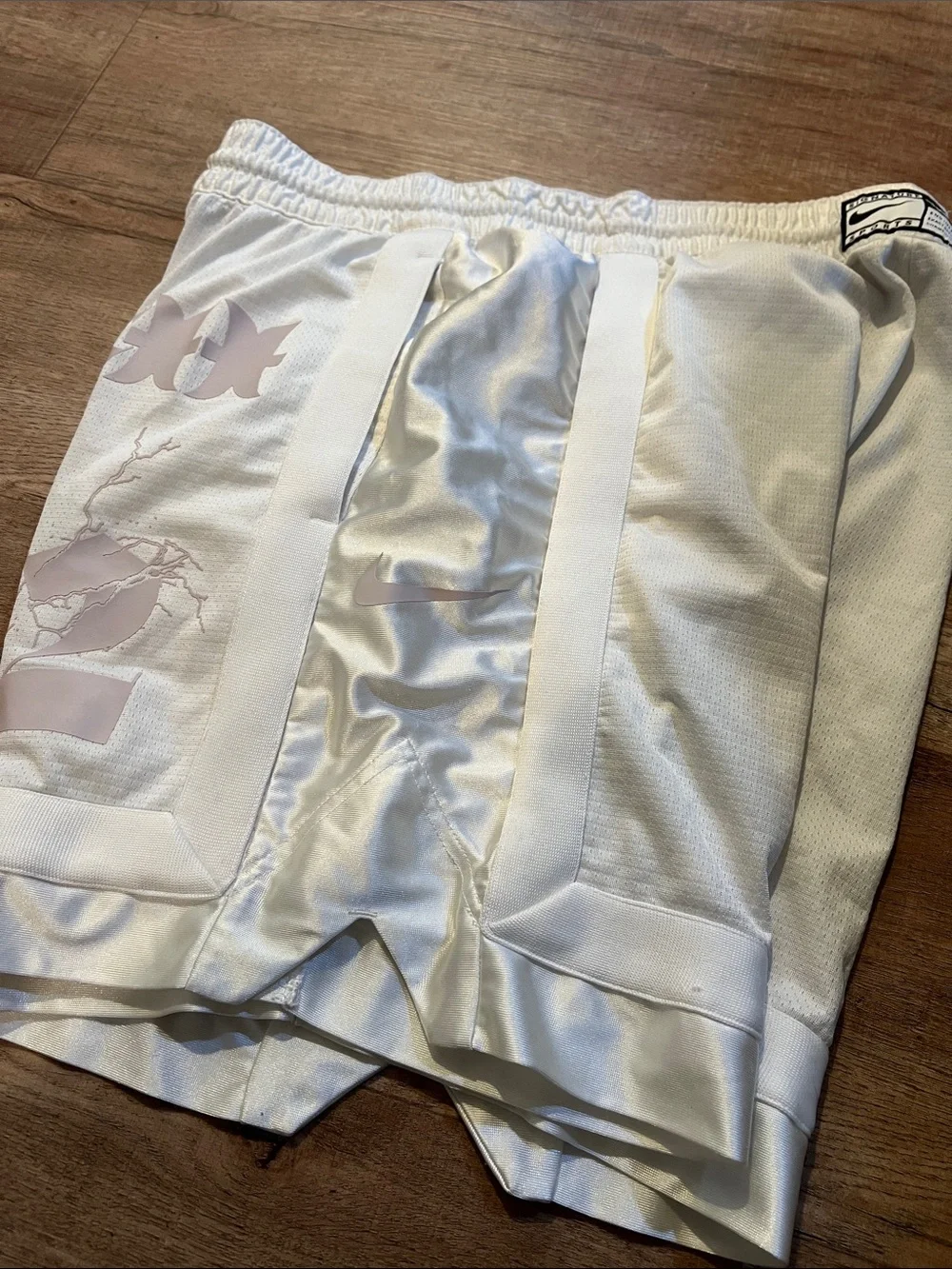 Nike Men’s White Athletic Shorts with Pale Pink Graphic